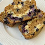 Blueberry Cream Cheese Bread sliced with visible blueberry and cream cheese swirls