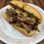Crockpot French Dip Sandwiches with melted cheese and juicy beef