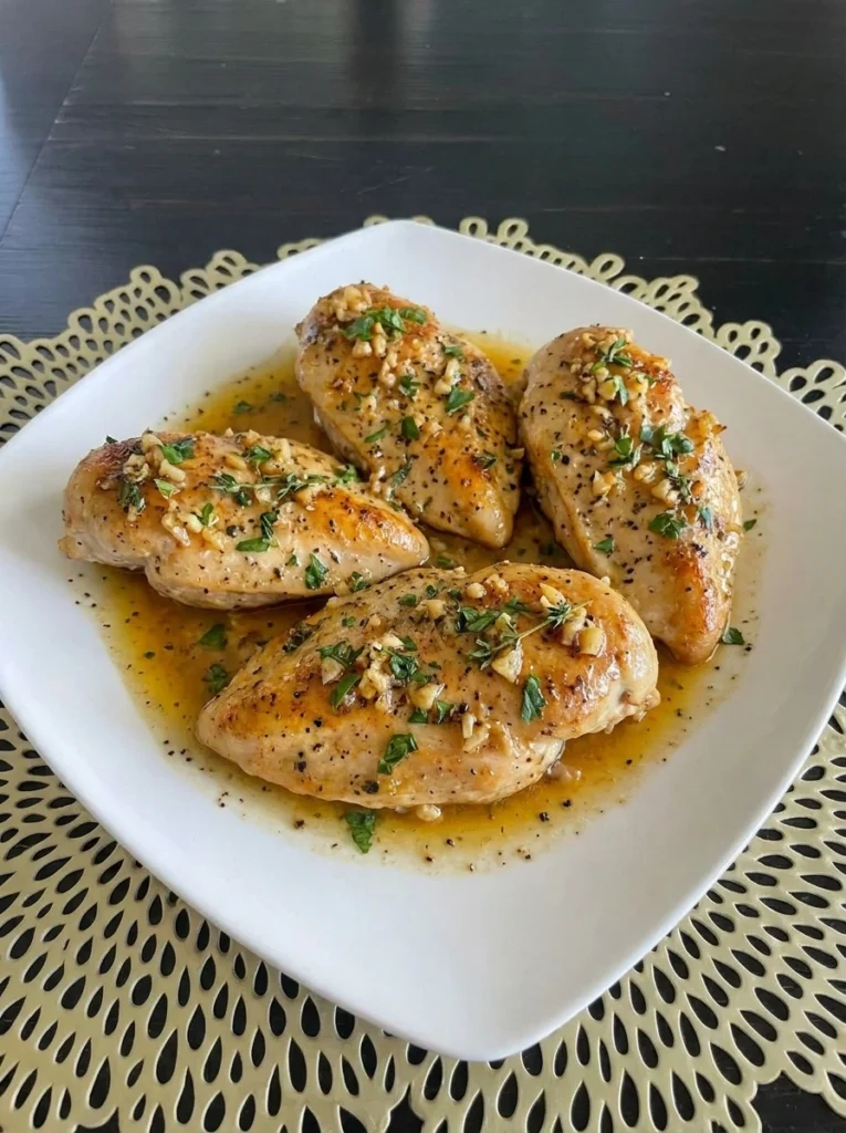 Crockpot Garlic Butter Chicken plated with rich sauce