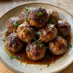 Firecracker Meatballs plated with glossy spicy sauce
