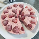 frozen strawberry lemonade pie slice with creamy filling and strawberry topping