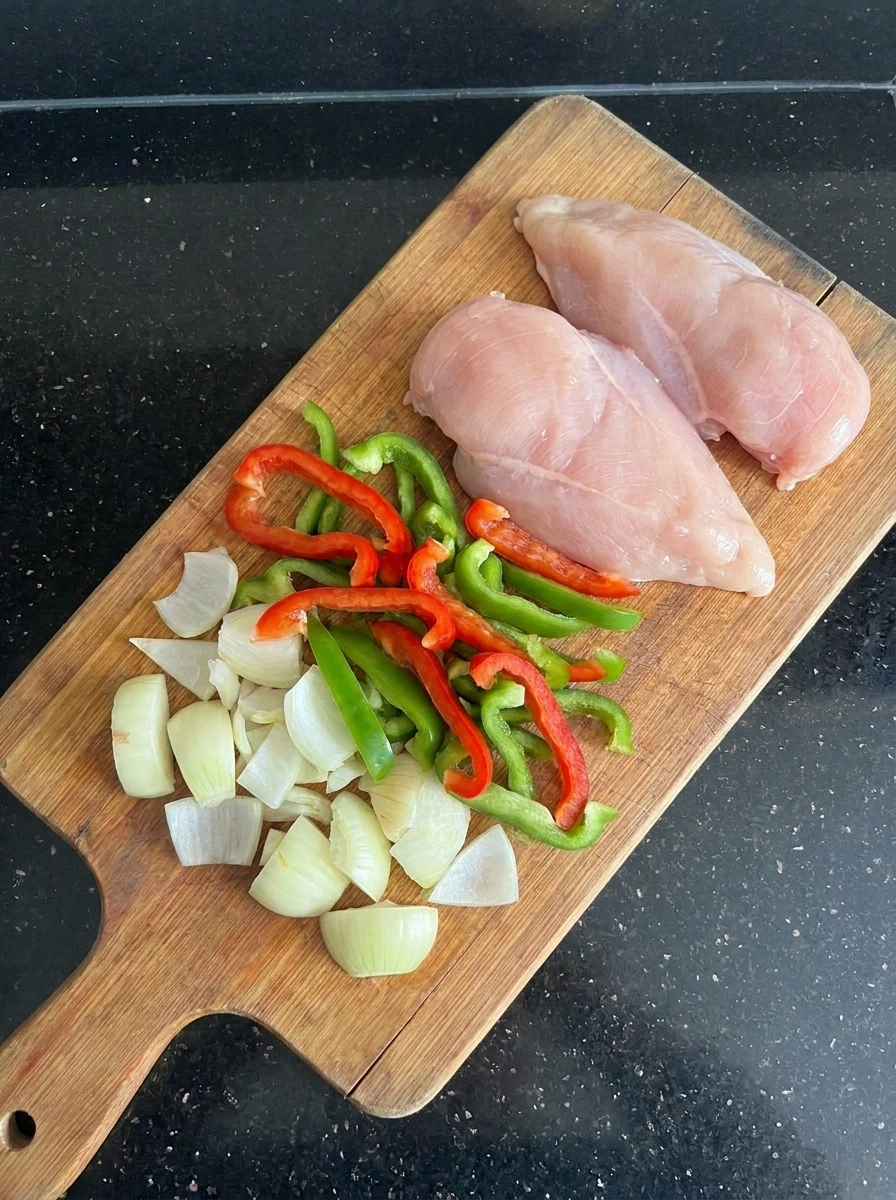 Sliced vegetables and raw chicken