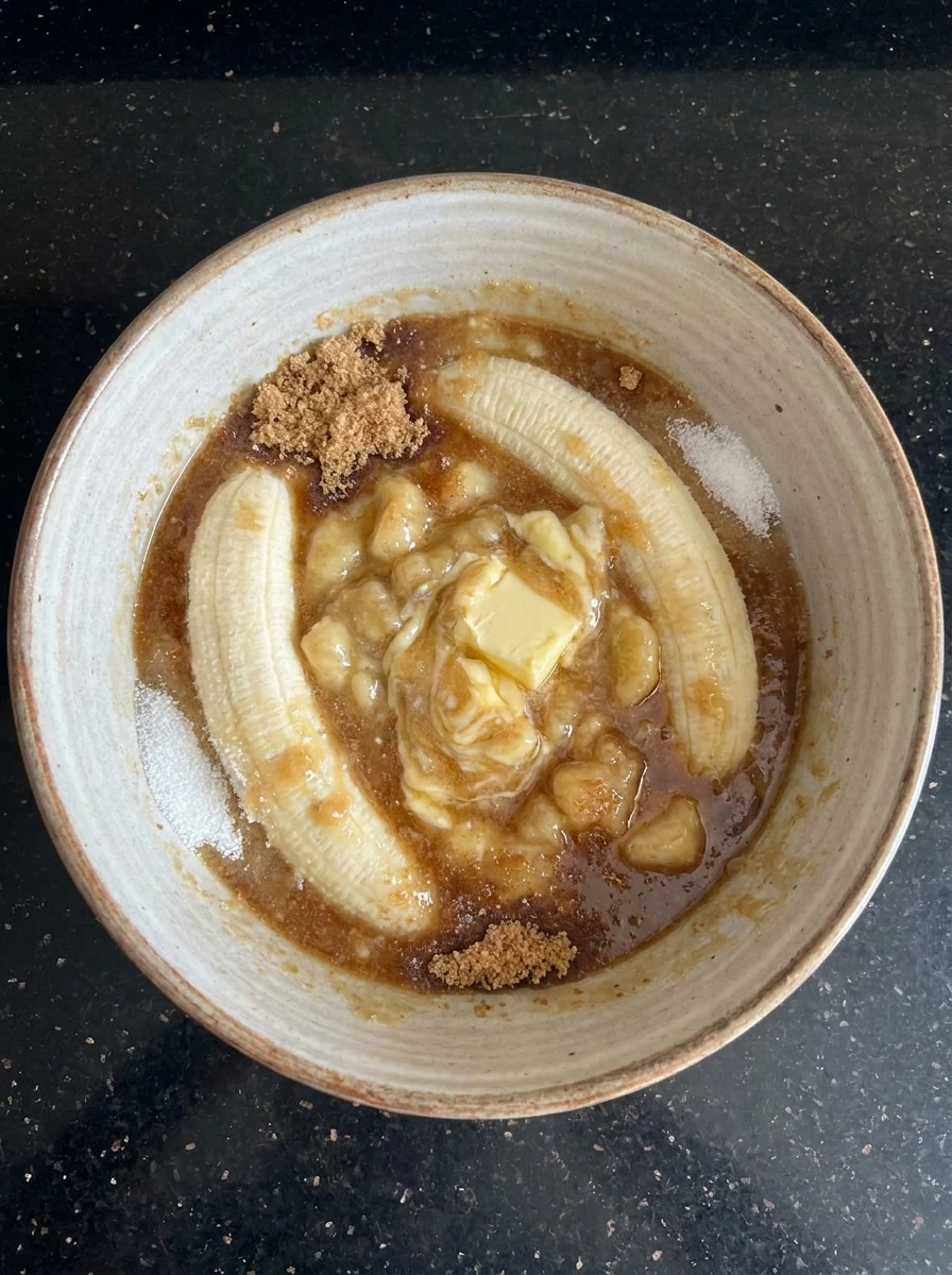 Mashed bananas mixed with butter and sugar for cookie dough.