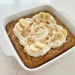Creamy Banana Pudding Brownies topped with whipped topping and vanilla wafers