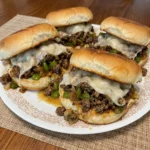 Cheesesteak Sloppy Joes with melted provolone on toasted buns