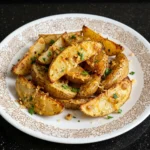 Crispy Garlic Parmesan Potato Wedges on a white plate