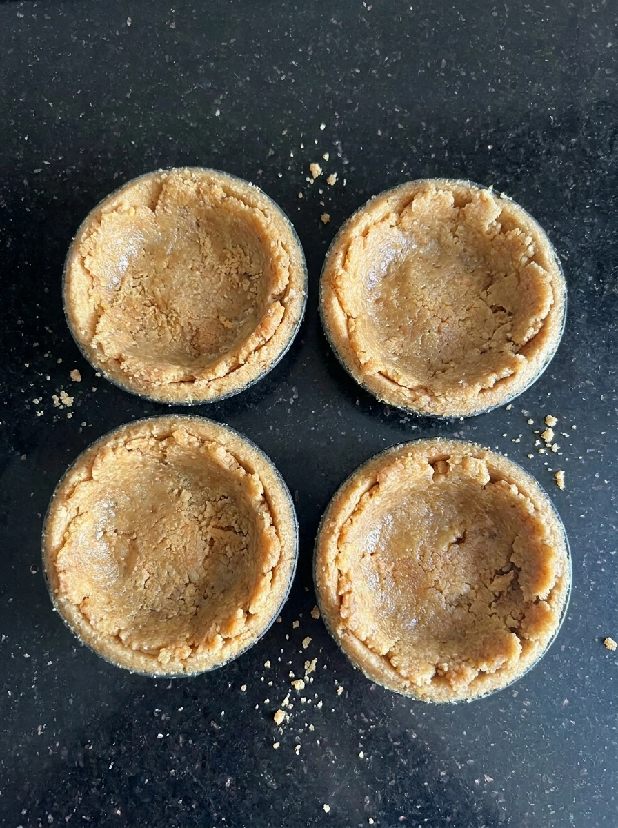 Vanilla wafer crust pressed into mini tart shells.