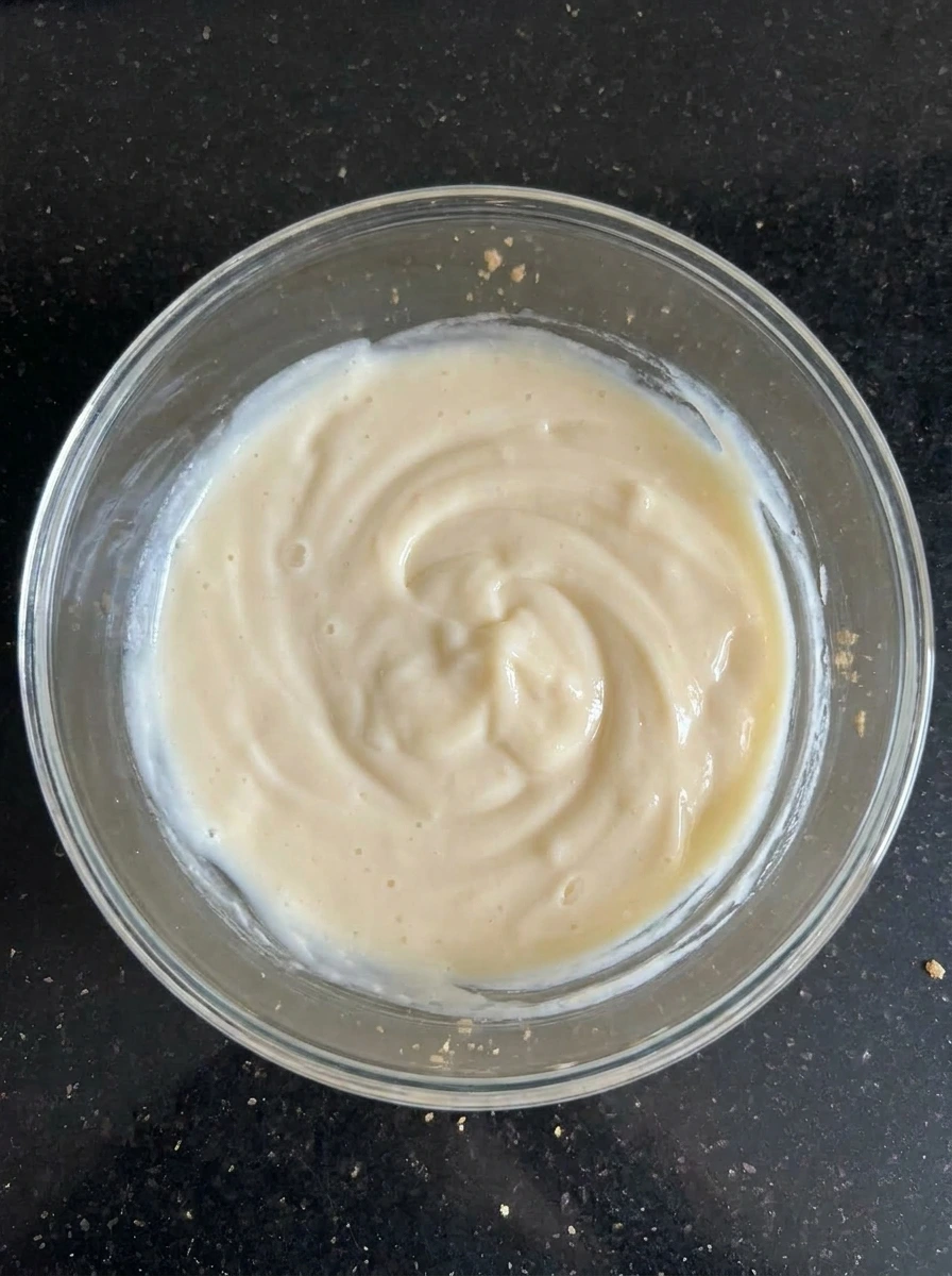 Creamy vanilla pudding filling being mixed.
