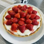 No bake strawberry cream pie slice with graham crust and fresh strawberries