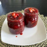 Homemade Strawberry Jam in glass jars with chunky berry texture