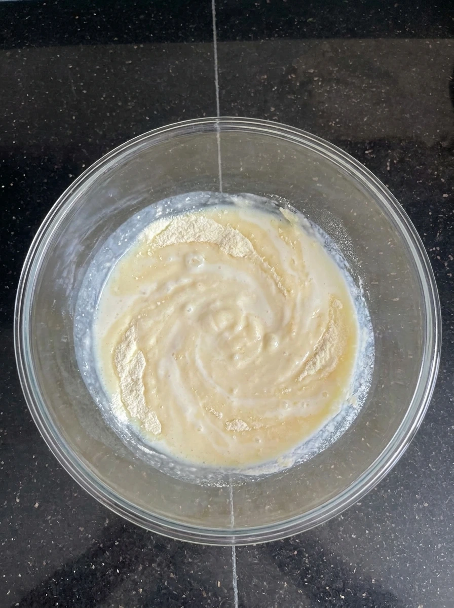 Vanilla pudding mixture thickening in bowl.