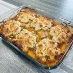 Best Ever Peach Cobbler with golden topping and bubbling peaches