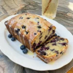 Blueberry Lemon Bread with lemon glaze and visible blueberries