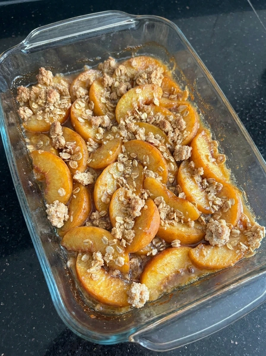Baked Buttery Peach Crisp with bubbling peaches and golden topping