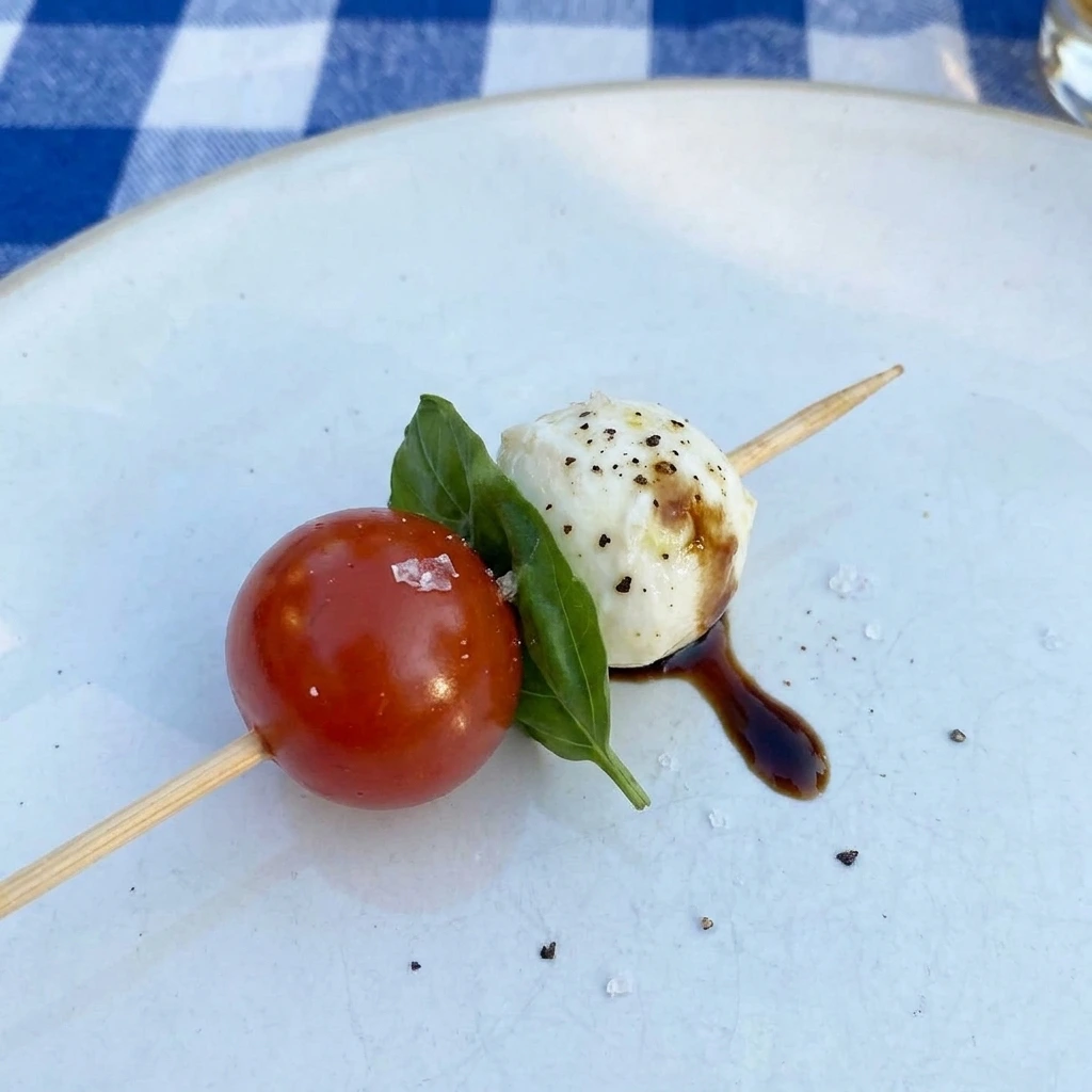Single serving of Caprese Skewers with balsamic glaze
