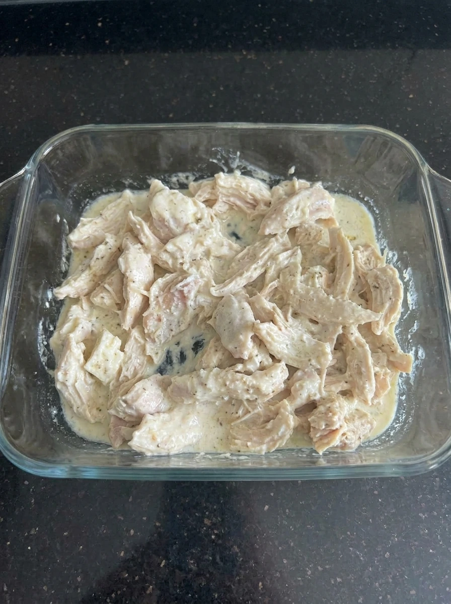 Shredded chicken folded into creamy sauce