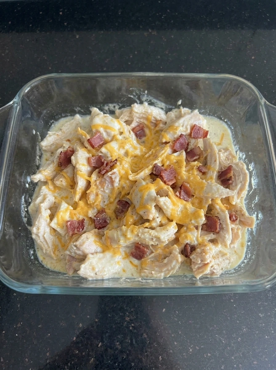 Crack Chicken topped with melted cheddar and bacon