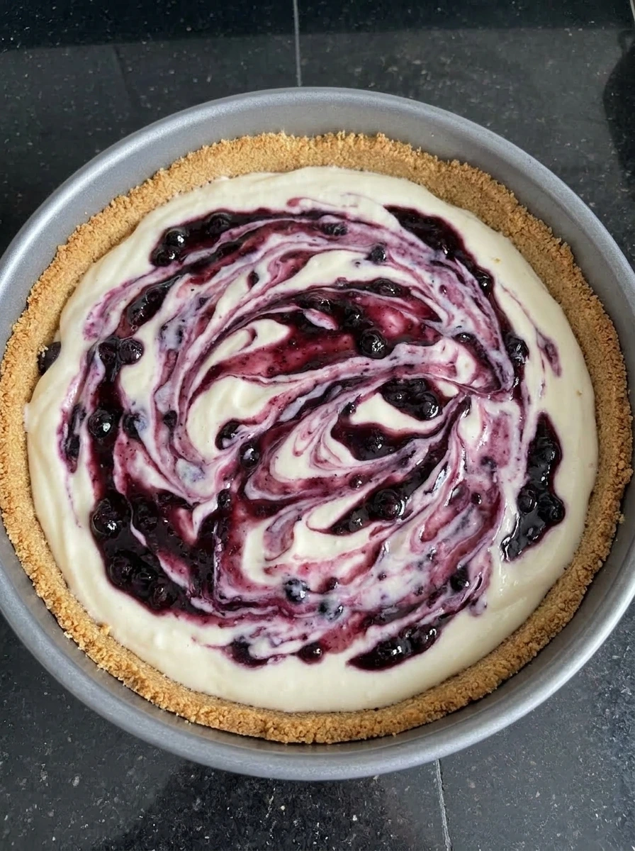 Huckleberry swirl added to Creamy Huckleberry Cheesecake