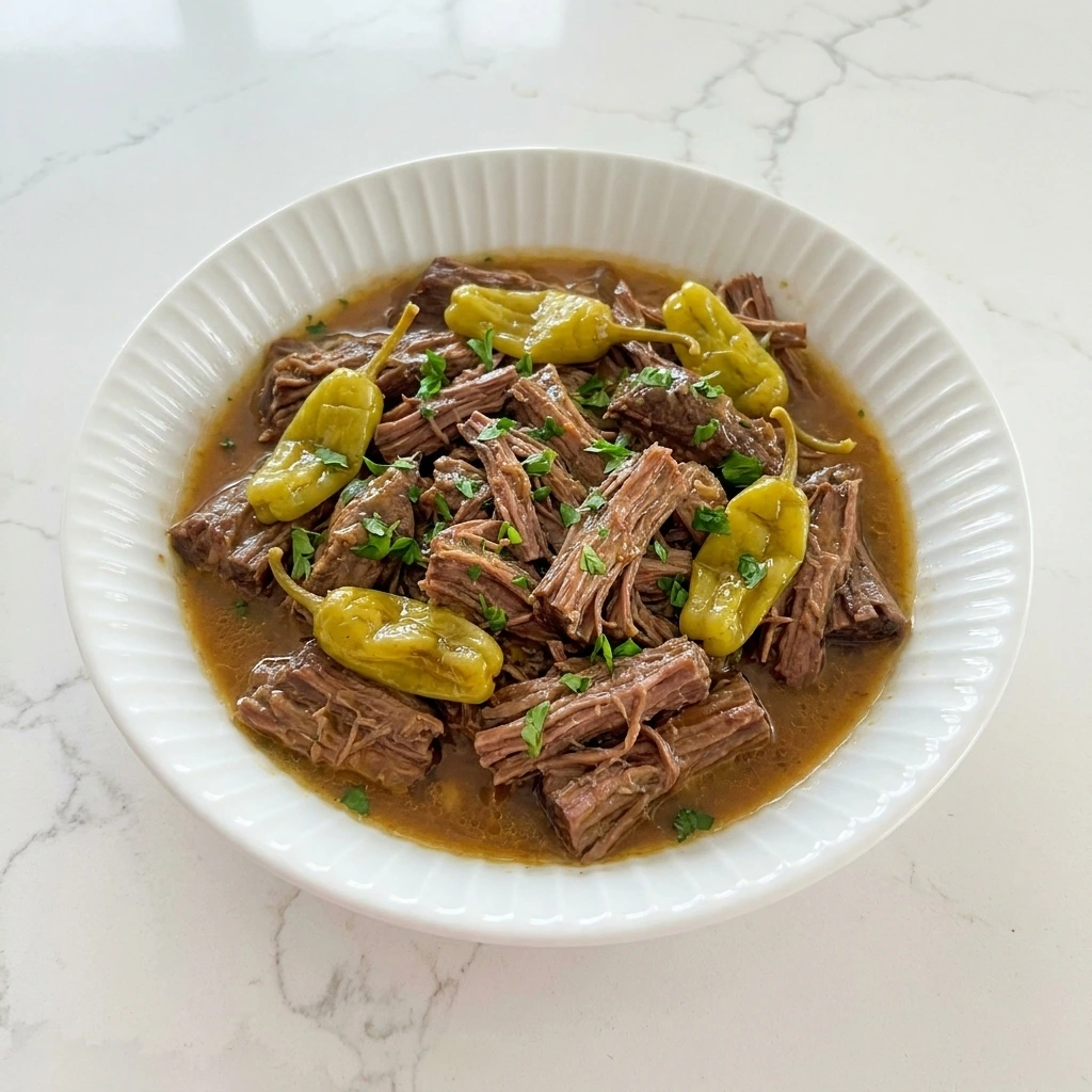 Crockpot Mississippi Pot Roast with tender shredded beef and pepperoncini