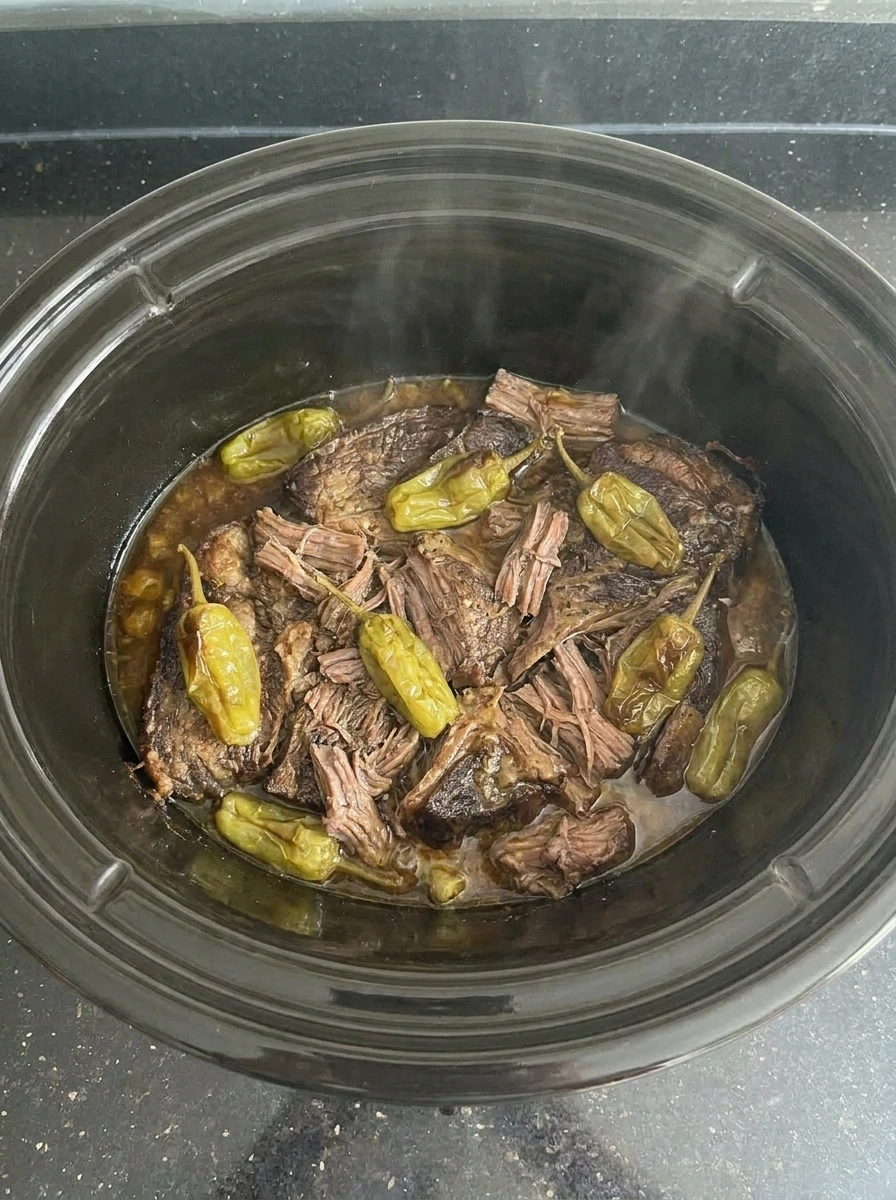 Shredded Crockpot Mississippi Pot Roast mixed with sauce