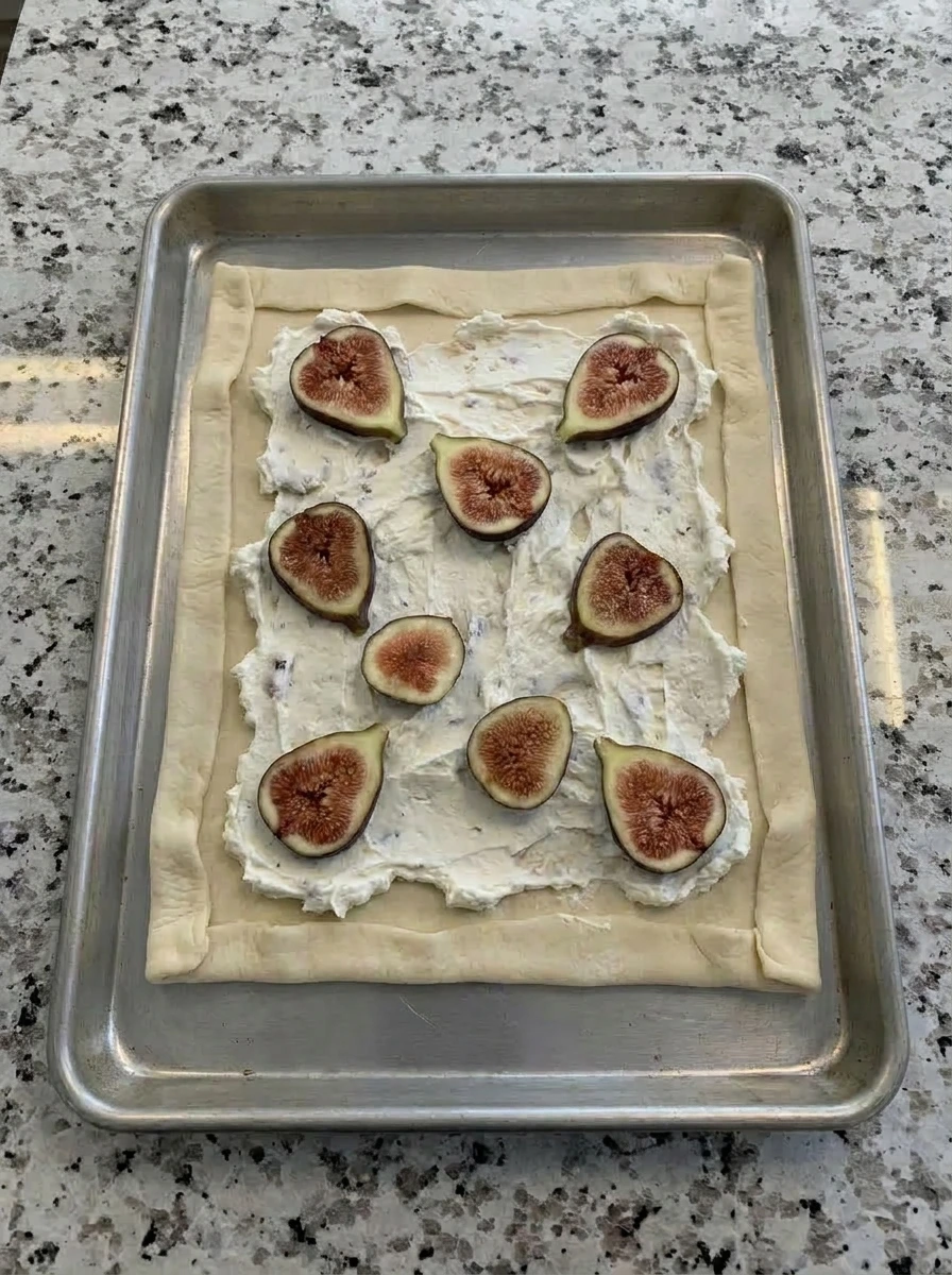 Sliced figs layered over goat cheese tart