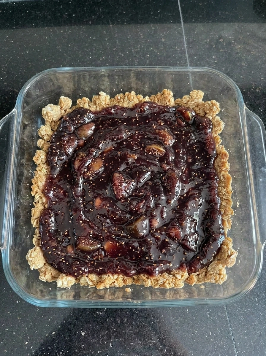Fig filling spread over crust for Fig Crumble Bars