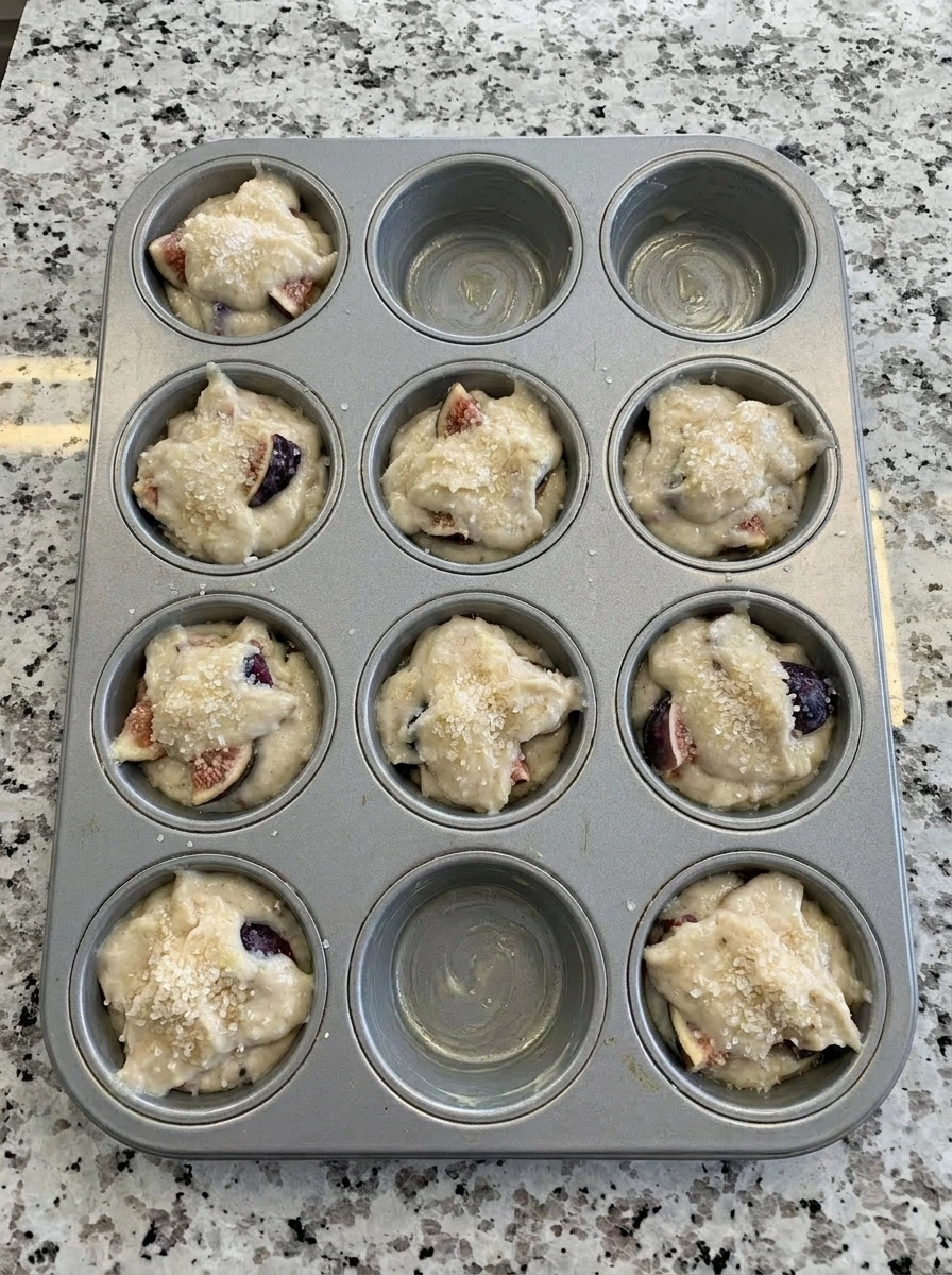 Muffin tin filled with Fresh Fig Muffins batter