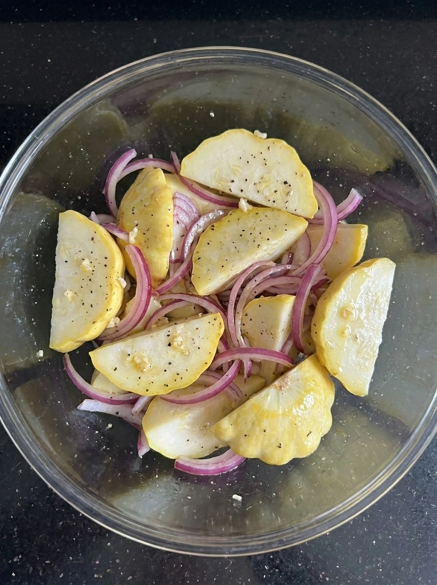 Patty pan squash and red onion coated with lemon dressing.