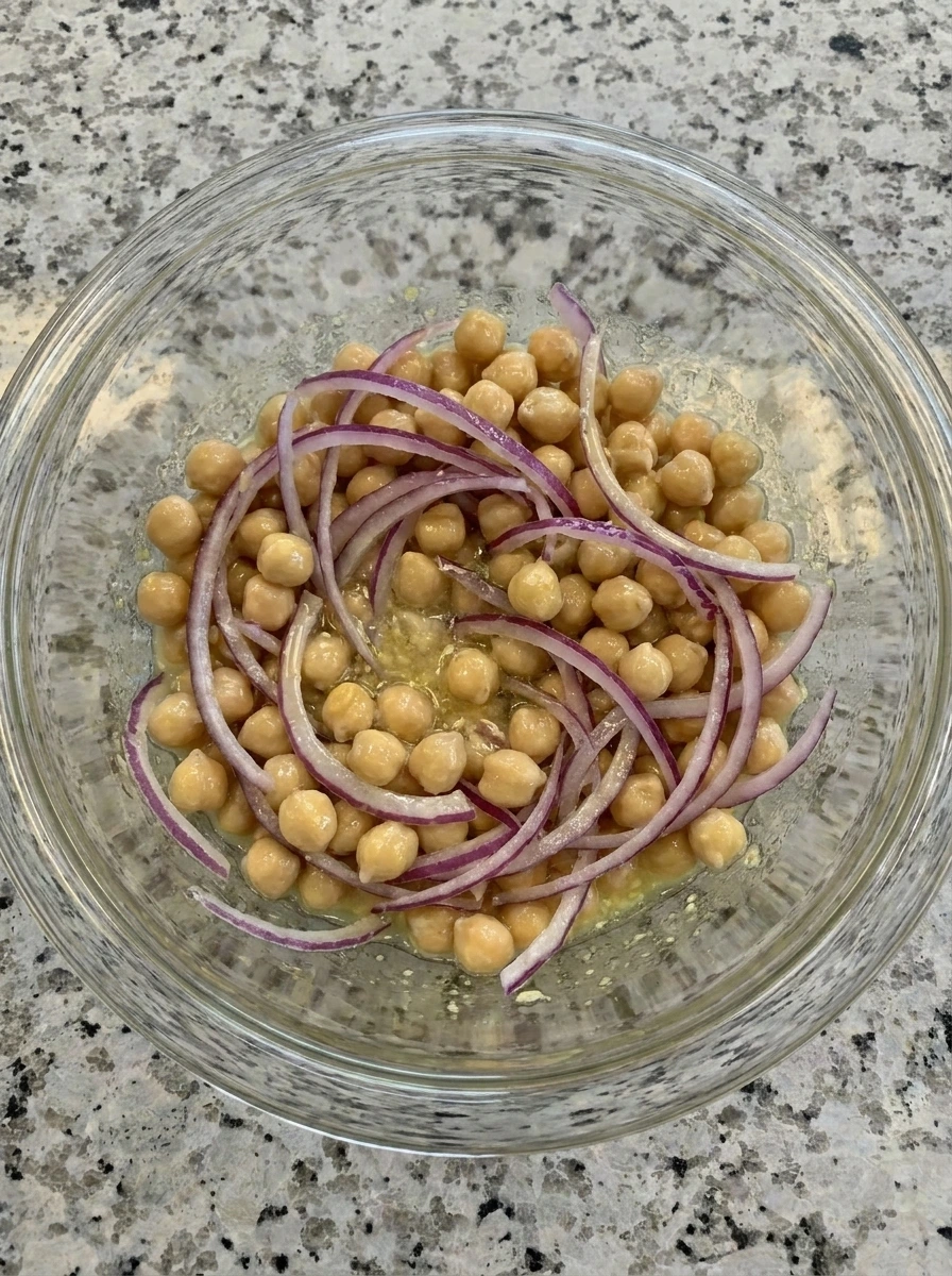 Chickpeas and red onion coated for Grilled Zucchini Chickpea Salad