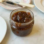 Homemade Fig Jam in a jar with glossy fig pieces