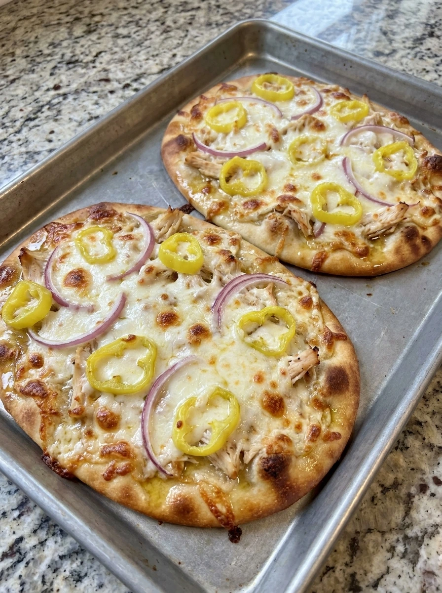 Baked Loaded Banana Pepper Flatbread with melted cheese and golden edges