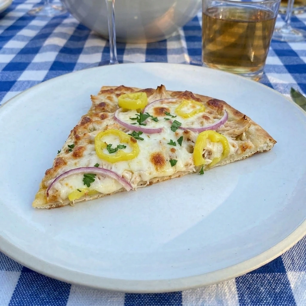 Single slice of Loaded Banana Pepper Flatbread served on a white plate