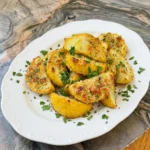 Parmesan Crusted Patty Pan Squash with golden cheesy crust and parsley on a white plate