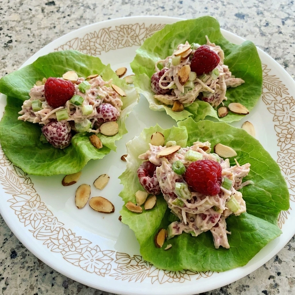 Single portion of Raspberry Chicken Salad Lettuce Cups topped with almonds