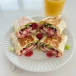 Raspberry Chicken Wraps with sliced chicken and creamy raspberry dressing
