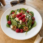 Raspberry Spinach Goat Cheese Salad with raspberries and goat cheese and toasted walnuts