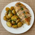 Sheet Pan Chicken and Potatoes with golden roasted potatoes and juicy sliced chicken