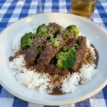 Slow Cooker Beef and Broccoli served with glossy sauce and tender broccoli