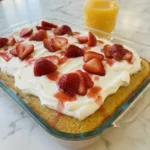 Strawberry Tres Leches Cake with whipped cream and fresh strawberries