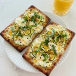 Zucchini and Herbed Ricotta Flatbread with browned edges and creamy ricotta
