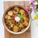 CrockPot Beefy Potato Taco Casserole with seasoned beef and tender potatoes under melted cheddar cheese