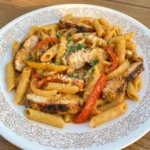 Creamy CrockPot Cajun Chicken Pasta with sliced chicken and bell peppers