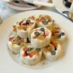 No Bake Cheesecake Sushi Rolls with strawberries blueberries and creamy filling